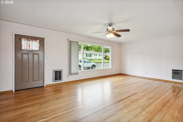 1831 E 14th St, The Dalles, OR 97058 - unfurnished living room with heating unit, ceiling fan, light wood-type flooring, and baseboards