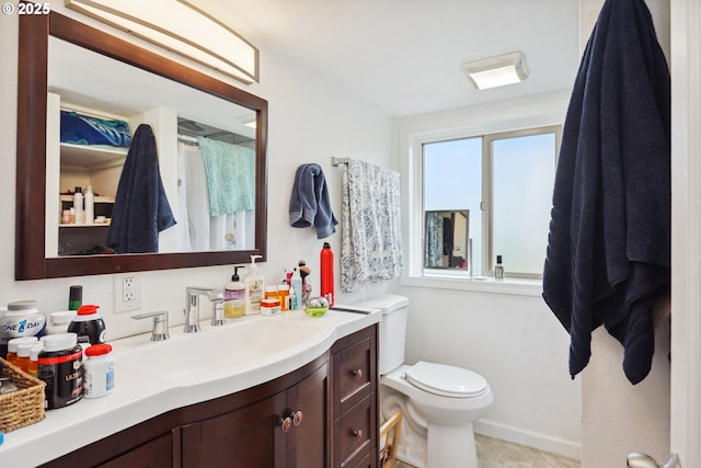 1831 E 14th St, The Dalles, OR 97058 - bathroom with toilet, vanity, and baseboards