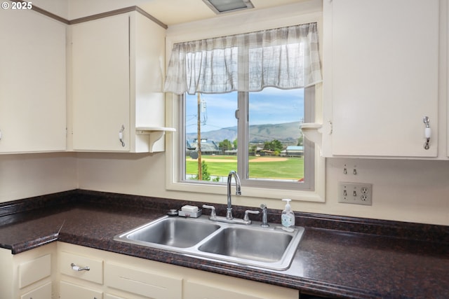 1831 E 14th St, The Dalles, OR 97058 - kitchen with a sink, white cabinetry, plenty of natural light, and dark countertops