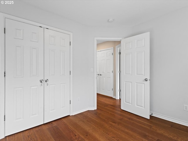 17575 SW Heatherwood Ln, Sherwood, OR 97140 - unfurnished bedroom with a closet, dark wood-style flooring, and baseboards