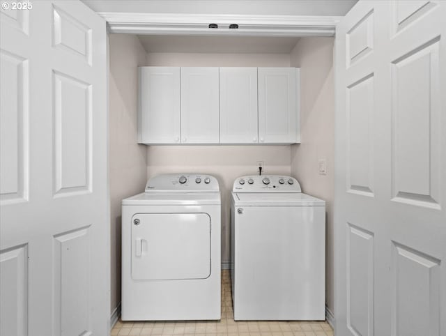 17575 SW Heatherwood Ln, Sherwood, OR 97140 - laundry room with washing machine and clothes dryer, light floors, and cabinet space