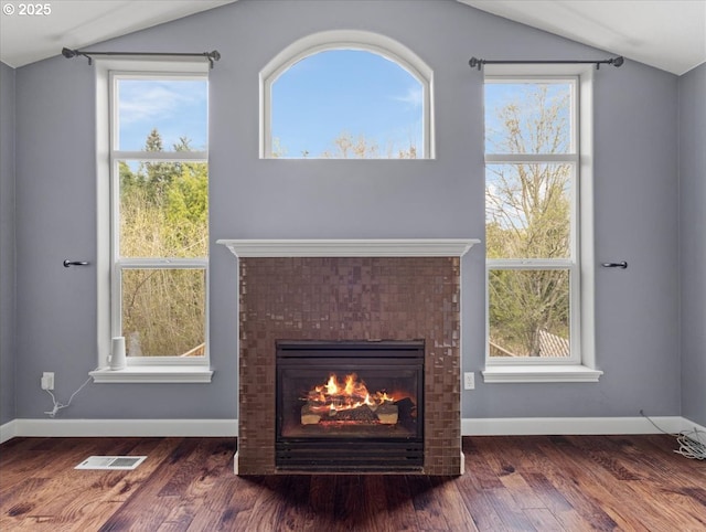 17575 SW Heatherwood Ln, Sherwood, OR 97140 - interior details with wood finished floors, visible vents, baseboards, and a brick fireplace