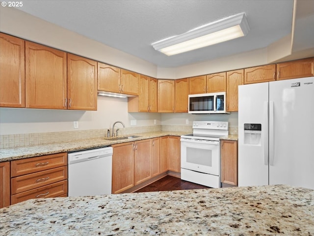 17575 SW Heatherwood Ln, Sherwood, OR 97140 - kitchen featuring light stone countertops, white appliances, dark wood-style flooring, and a sink