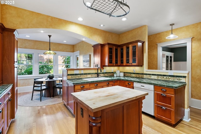 1816 NE 14th Ave, Portland, OR 97212 - kitchen featuring a sink, white dishwasher, butcher block countertops, a peninsula, and light wood-style flooring