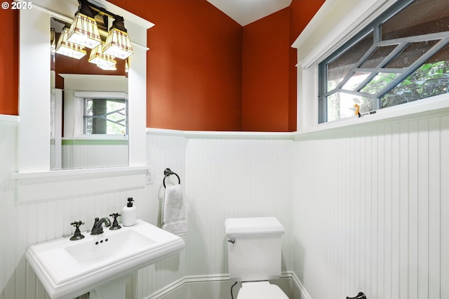 1816 NE 14th Ave, Portland, OR 97212 - half bath featuring a wainscoted wall, toilet, and a sink