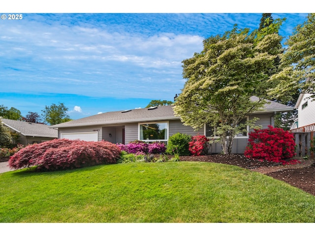 ranch-style house with a front lawn and a garage