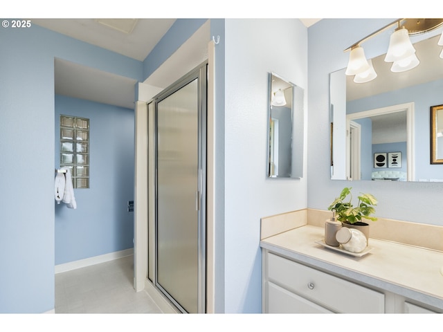 bathroom featuring vanity and a shower stall