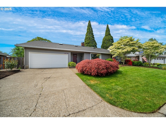 ranch-style house featuring a chimney, a front yard, a garage, fence, and concrete driveway