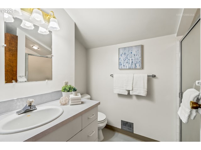 bathroom featuring toilet, visible vents, a shower stall, and vanity