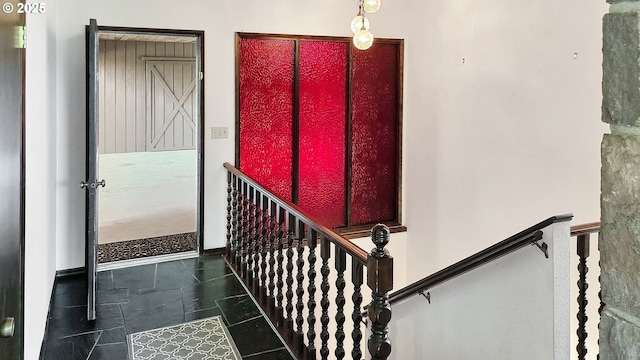 stairs with tile patterned floors and baseboards