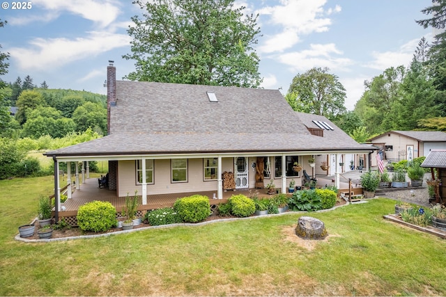 241 Growlers Gulch Rd, Castle Rock, WA 98611 - back of property featuring a lawn, roof with shingles, a chimney, and a porch