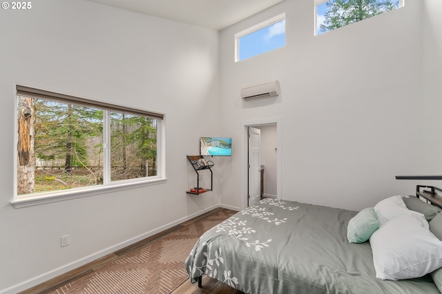 119/121 Tioga Ln, Idleyld Park, OR 97447 - bedroom featuring a wall mounted AC, a towering ceiling, and baseboards