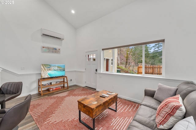 119/121 Tioga Ln, Idleyld Park, OR 97447 - living room featuring high vaulted ceiling, a wall mounted AC, baseboards, wood finished floors, and recessed lighting
