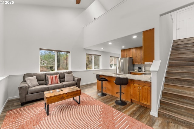 119/121 Tioga Ln, Idleyld Park, OR 97447 - living area with dark wood finished floors, a high ceiling, stairway, recessed lighting, and baseboards