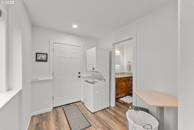 119/121 Tioga Ln, Idleyld Park, OR 97447 - washroom featuring stacked washing machine and dryer, light wood-style floors, recessed lighting, and baseboards