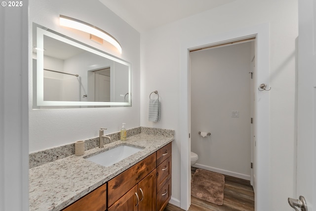 119/121 Tioga Ln, Idleyld Park, OR 97447 - bathroom with vanity, wood finished floors, toilet, baseboards, and a shower