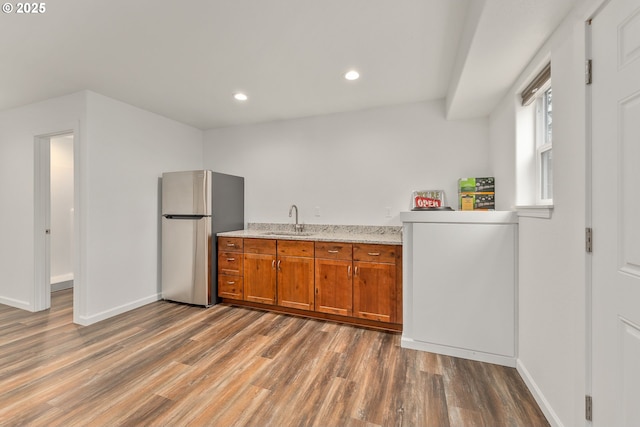 119/121 Tioga Ln, Idleyld Park, OR 97447 - kitchen featuring freestanding refrigerator, brown cabinetry, wood finished floors, a sink, and baseboards