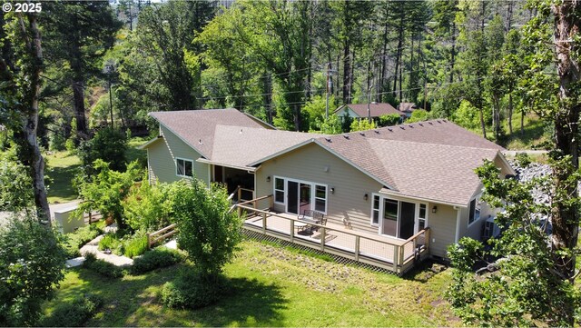 119/121 Tioga Ln, Idleyld Park, OR 97447 - back of house with a shingled roof, a lawn, a deck, and a view of trees