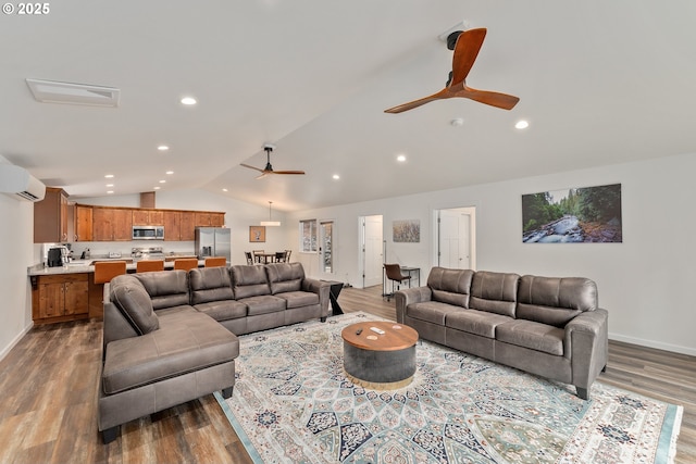 living room with hardwood / wood-style flooring, ceiling fan, vaulted ceiling, and a wall unit AC