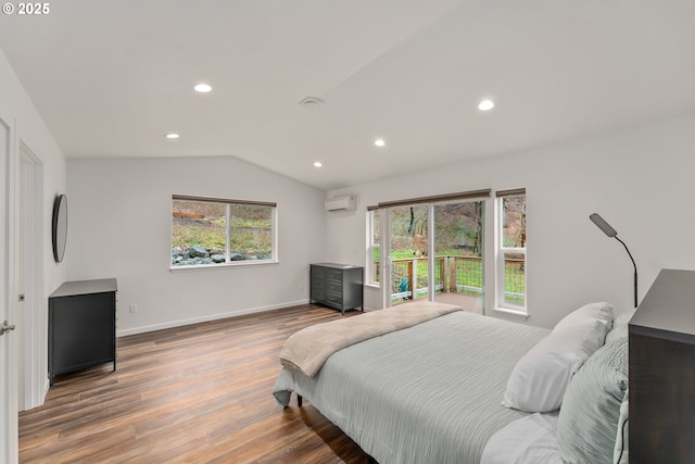119/121 Tioga Ln, Idleyld Park, OR 97447 - bedroom featuring a wall mounted air conditioner, wood finished floors, recessed lighting, vaulted ceiling, and baseboards