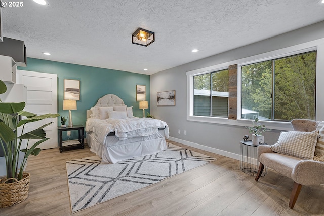 19434 S Logan Dr, Beavercreek, OR 97004 - bedroom with recessed lighting, wood finished floors, and a textured ceiling