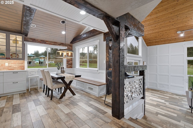 19434 S Logan Dr, Beavercreek, OR 97004 - dining area featuring lofted ceiling, a decorative wall, light wood-style flooring, wood ceiling, and a wainscoted wall