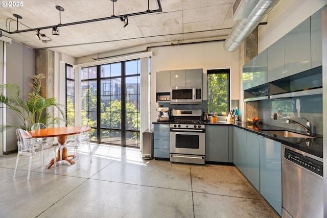 1030 NW 12th Ave Unit 201, Portland, OR 97209 - kitchen with appliances with stainless steel finishes, dark countertops, gray cabinetry, and modern cabinets