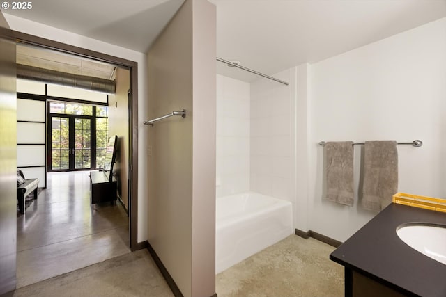 1030 NW 12th Ave Unit 201, Portland, OR 97209 - full bath with concrete flooring, vanity, shower / washtub combination, and french doors