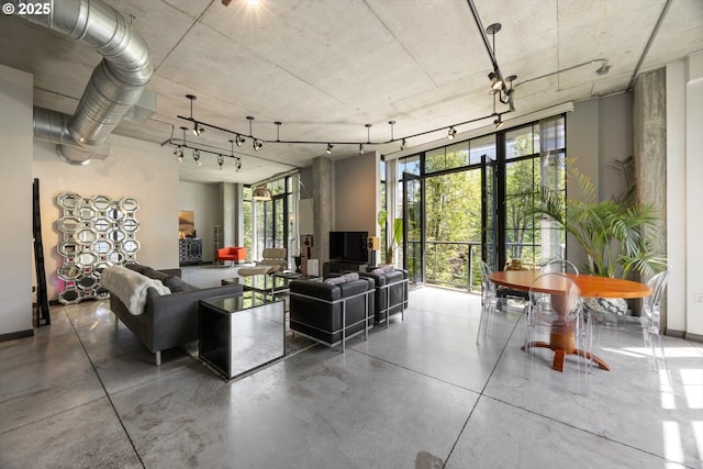 1030 NW 12th Ave Unit 201, Portland, OR 97209 - living room with a wall of windows and concrete flooring