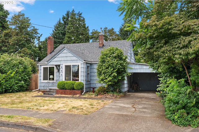 250 17th St, Springfield, OR 97477 - bungalow-style home with a chimney, an attached carport, a shingled roof, and concrete driveway