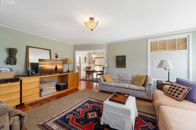 living room with ornamental molding and wood finished floors