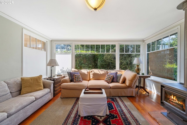 sunroom with wood finished floors and crown molding