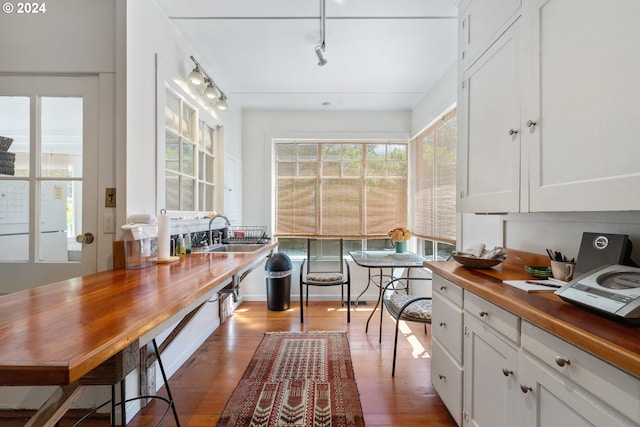 interior space featuring track lighting and wood finished floors