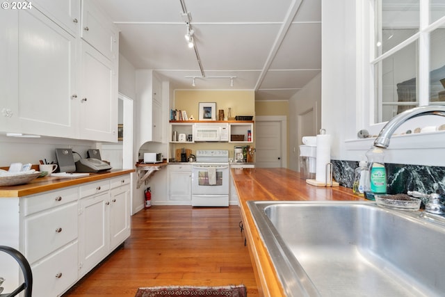 kitchen featuring white cabinetry, white appliances, wood-type flooring, a sink, and stainless steel countertops