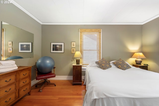 bedroom featuring baseboards, light wood-style floors, and ornamental molding