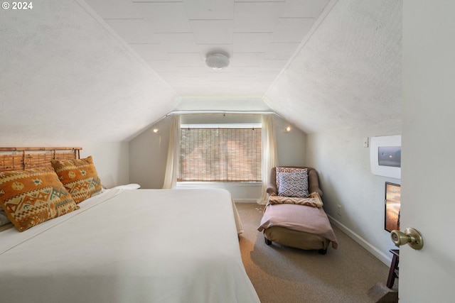 carpeted bedroom with baseboards, a textured ceiling, and vaulted ceiling