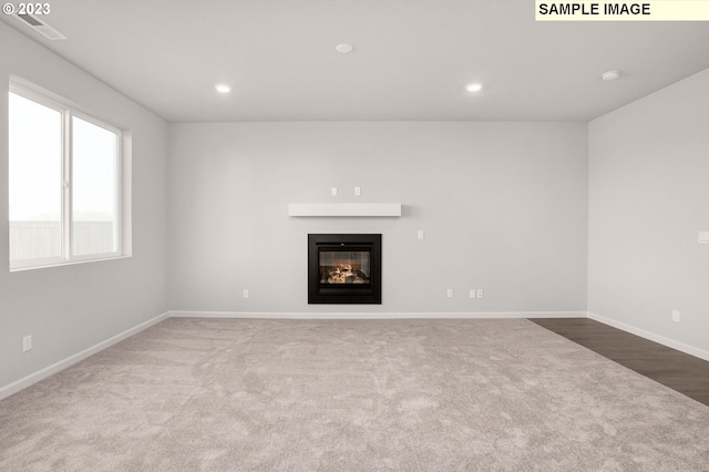 6286 SE 20th St, Gresham, OR 97080 - unfurnished living room featuring carpet, a glass covered fireplace, baseboards, and recessed lighting