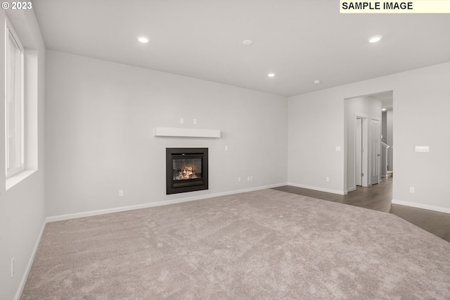 6286 SE 20th St, Gresham, OR 97080 - unfurnished living room featuring dark colored carpet, recessed lighting, a glass covered fireplace, and baseboards