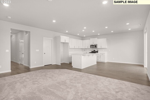 6286 SE 20th St, Gresham, OR 97080 - kitchen featuring appliances with stainless steel finishes, open floor plan, a kitchen island with sink, recessed lighting, and white cabinetry