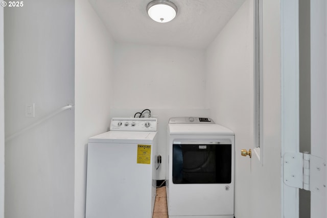 laundry room with laundry area, washer and clothes dryer, and a textured ceiling