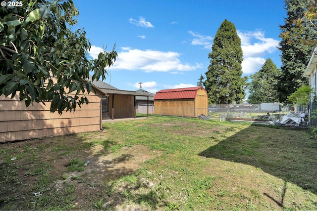 view of yard featuring a storage shed and fence