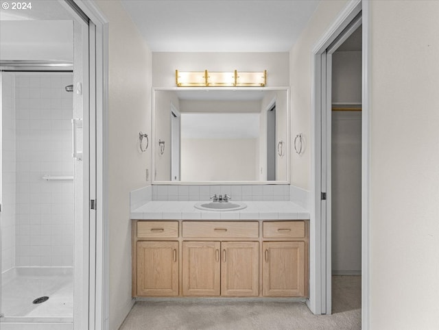 bathroom featuring vanity and an enclosed shower