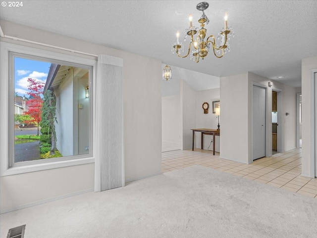 dining room featuring a textured ceiling, light carpet, and an inviting chandelier