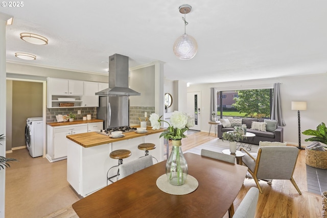 dining room featuring baseboards and washer / dryer