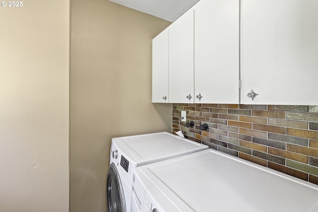 washroom featuring washer and dryer and cabinet space