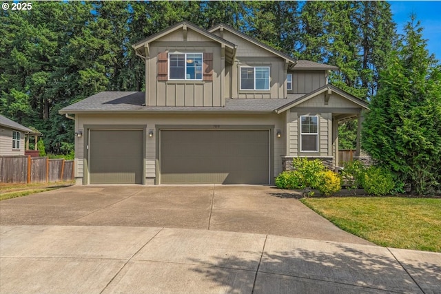 7010 SW Barr Ln, Tualatin, OR 97062 - view of front of property with board and batten siding, driveway, an attached garage, and a shingled roof