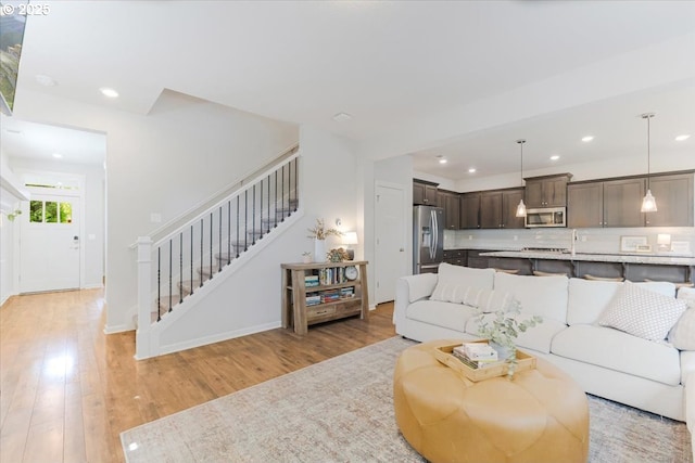 7010 SW Barr Ln, Tualatin, OR 97062 - living area with recessed lighting, stairs, and light wood-style floors