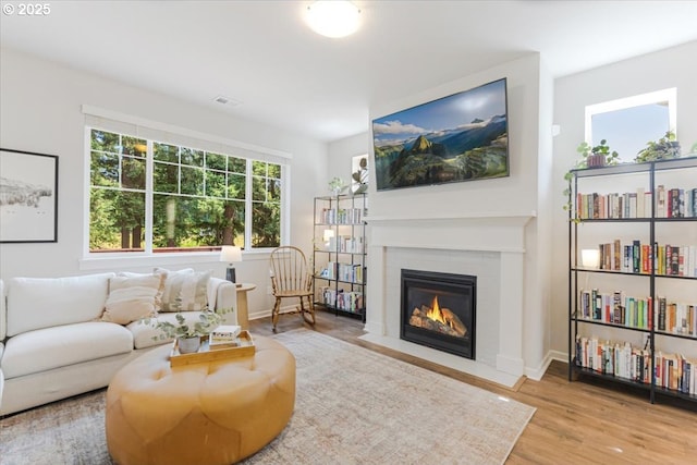 7010 SW Barr Ln, Tualatin, OR 97062 - living room featuring a fireplace with flush hearth and wood finished floors