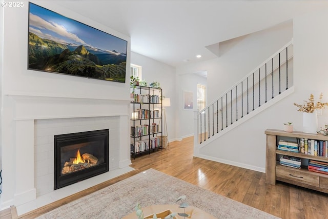 7010 SW Barr Ln, Tualatin, OR 97062 - living room with wood finished floors, recessed lighting, stairway, and a fireplace with flush hearth