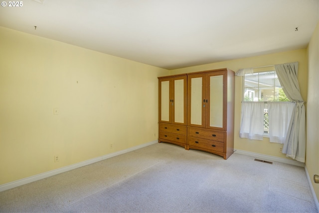 bedroom with light colored carpet, baseboards, and visible vents
